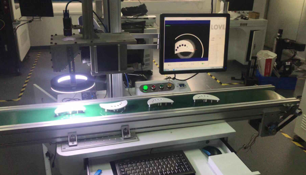 Production Line for Vision-Based Positioning and Laser Marking of Plastic Components